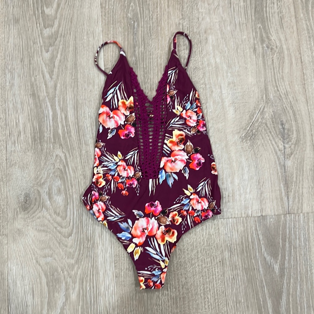 Billabong one piece swim. New condition. Size M. Purple floral with crochet.